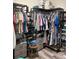 Organized walk-in closet with shelves, drawers, rods, shoes and clothing on display at 16840 Whisper Elm St, Wimauma, FL 33598