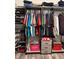 Organized walk-in closet with shelves, drawers, rods, shoes and clothing on display at 16840 Whisper Elm St, Wimauma, FL 33598
