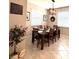 Dining room with a wooden table, six chairs, modern light fixture, and neutral walls at 16840 Whisper Elm St, Wimauma, FL 33598