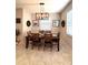 Dining room with a wooden table, six chairs, modern light fixture, and neutral walls at 16840 Whisper Elm St, Wimauma, FL 33598
