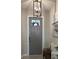 Bright foyer with a gray front door, a decorative light fixture, and a coastal themed art to add a coastal touch at 16840 Whisper Elm St, Wimauma, FL 33598