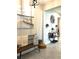 Hallway area with beach themed decor, a small bench, a lantern, and a console table with displayed flower vases at 16840 Whisper Elm St, Wimauma, FL 33598