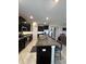 Open-concept kitchen with a large island and breakfast bar, stainless steel appliances, and dark cabinets at 16840 Whisper Elm St, Wimauma, FL 33598