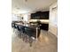 Open-concept kitchen with a large island and breakfast bar, stainless steel appliances, and dark cabinets at 16840 Whisper Elm St, Wimauma, FL 33598