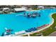 Expansive lagoon with an inflatable park and paddle boards offers recreational opportunities for residents at 16840 Whisper Elm St, Wimauma, FL 33598