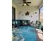 Spacious outdoor lanai with comfortable seating, decor, and ceiling fan at 16840 Whisper Elm St, Wimauma, FL 33598