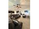 Open-concept living room showcasing tile floors, a sofa, and adjacent kitchen at 16840 Whisper Elm St, Wimauma, FL 33598