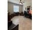 Spacious office with neutral walls and ceiling fan over tile flooring, plus multiple seating areas at 16840 Whisper Elm St, Wimauma, FL 33598