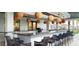 Covered outdoor bar features a sleek countertop, ample seating, and stylish lighting for entertaining at 16840 Whisper Elm St, Wimauma, FL 33598
