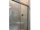 Tiled shower with a glass door and a built-in seat offering a spa-like experience at 16840 Whisper Elm St, Wimauma, FL 33598