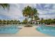 Resort-style swimming pool with a central island and lush landscaping, perfect for relaxation and recreation at 16840 Whisper Elm St, Wimauma, FL 33598