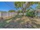 Wide view of a fully fenced-in yard with manicured lawn and mature shade trees at 1710 S Lake Ave, Clearwater, FL 33756