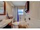 Neat bathroom featuring a classic vanity, a shower and tub combination, and storage at 1710 S Lake Ave, Clearwater, FL 33756