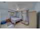 Light and cozy bedroom featuring a bed, window, closet, and practical furnishings at 1710 S Lake Ave, Clearwater, FL 33756