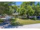 Home with a well maintained lawn, mature trees and a paved driveway at 1710 S Lake Ave, Clearwater, FL 33756