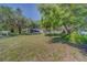 An attractive front lawn and mature trees provide curb appeal for this charming home at 1710 S Lake Ave, Clearwater, FL 33756
