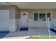 Inviting front porch features white tile flooring, brick accents, and a charming front door at 1710 S Lake Ave, Clearwater, FL 33756