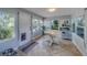 Sunroom featuring tile flooring, access door, and multiple windows allowing natural light into the room at 1710 S Lake Ave, Clearwater, FL 33756