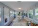Sunroom with tile flooring and numerous windows offering ample natural light and views of the outdoors at 1710 S Lake Ave, Clearwater, FL 33756