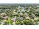 Aerial view of a residential area with waterfront properties and lush greenery around a lake at 19708 Wellington Manor Blvd, Lutz, FL 33549