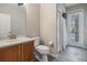 Bathroom featuring a vanity with a solid surface countertop, a toilet, and a shower/tub combo at 19708 Wellington Manor Blvd, Lutz, FL 33549