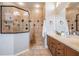Bathroom featuring a glass enclosed shower and double sink vanity offering style and functionality at 19708 Wellington Manor Blvd, Lutz, FL 33549