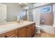 Bathroom showcasing a vanity with ample storage, a large mirror, and a shower/tub combo at 19708 Wellington Manor Blvd, Lutz, FL 33549