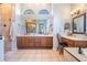 Elegant bathroom with a walk-in shower, large vanity, and a charming makeup table at 19708 Wellington Manor Blvd, Lutz, FL 33549