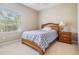 Well-lit bedroom featuring a comfortable bed and a window with views of the outdoors at 19708 Wellington Manor Blvd, Lutz, FL 33549
