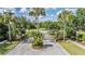 Gated community entrance with stone pillars, lush landscaping, and mature palm trees at 19708 Wellington Manor Blvd, Lutz, FL 33549