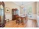 Dining room featuring wood floors, traditional furniture, and arched windows at 19708 Wellington Manor Blvd, Lutz, FL 33549