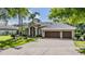 Charming home featuring a spacious three car garage, paver driveway, and beautiful landscaping at 19708 Wellington Manor Blvd, Lutz, FL 33549
