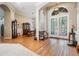 Elegant foyer with hardwood floors, decorative glass doors, and arched doorways leading to formal dining at 19708 Wellington Manor Blvd, Lutz, FL 33549