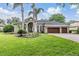 Attractive home featuring a well-maintained lawn and beautiful curb appeal with mature landscaping at 19708 Wellington Manor Blvd, Lutz, FL 33549