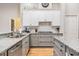 This kitchen features granite countertops, modern appliances, ample cabinetry, and an island for food prep at 19708 Wellington Manor Blvd, Lutz, FL 33549