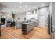 Open kitchen features granite countertops, an island with seating, and stainless steel appliances at 19708 Wellington Manor Blvd, Lutz, FL 33549