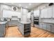 Bright kitchen boasts granite countertops, an island with seating, stainless steel appliances, and hardwood floors at 19708 Wellington Manor Blvd, Lutz, FL 33549