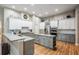 This kitchen features granite countertops, modern appliances, an island with storage, and a tile backsplash at 19708 Wellington Manor Blvd, Lutz, FL 33549