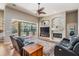 Cozy living room showcases a fireplace, access to the pool area, and comfortable seating at 19708 Wellington Manor Blvd, Lutz, FL 33549