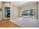 Bright living room with large sliding glass doors to the screened pool area and connecting bedroom at 19708 Wellington Manor Blvd, Lutz, FL 33549