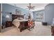 Spacious main bedroom features a ceiling fan and a large window with views to the outside at 19708 Wellington Manor Blvd, Lutz, FL 33549