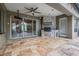 Outdoor kitchen with a tile backsplash, grill, ceiling fan, and access to the pool at 19708 Wellington Manor Blvd, Lutz, FL 33549