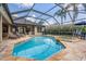 Inviting screened pool and spa with outdoor seating, perfect for relaxation and entertainment at 19708 Wellington Manor Blvd, Lutz, FL 33549