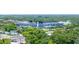 Aerial view of TD Ballpark, surrounded by a vibrant green landscape, with residential areas and clear blue sky above at 250 Aberdeen St, Dunedin, FL 34698