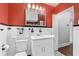 Bathroom featuring orange walls, black and white tile, a toilet, and a shower at 250 Aberdeen St, Dunedin, FL 34698