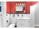Bathroom featuring orange walls, black and white tile, a toilet, and a shower at 250 Aberdeen St, Dunedin, FL 34698