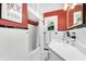 Bright bathroom with classic tile, tub and shower, and a framed mirror at 250 Aberdeen St, Dunedin, FL 34698