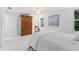 Bright bedroom featuring white tiled floors, a wardrobe, and a bed with fresh linens and throw pillows at 250 Aberdeen St, Dunedin, FL 34698