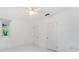 White bedroom with a ceiling fan and two closets and windows showing outside at 250 Aberdeen St, Dunedin, FL 34698