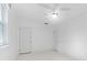 White bedroom with a ceiling fan and two closets and windows showing outside at 250 Aberdeen St, Dunedin, FL 34698